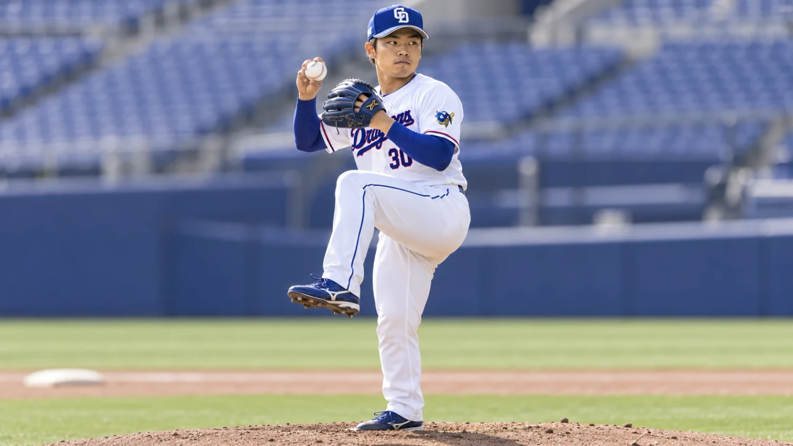 マウンド上で片足を上げ、ボールを持つ投手