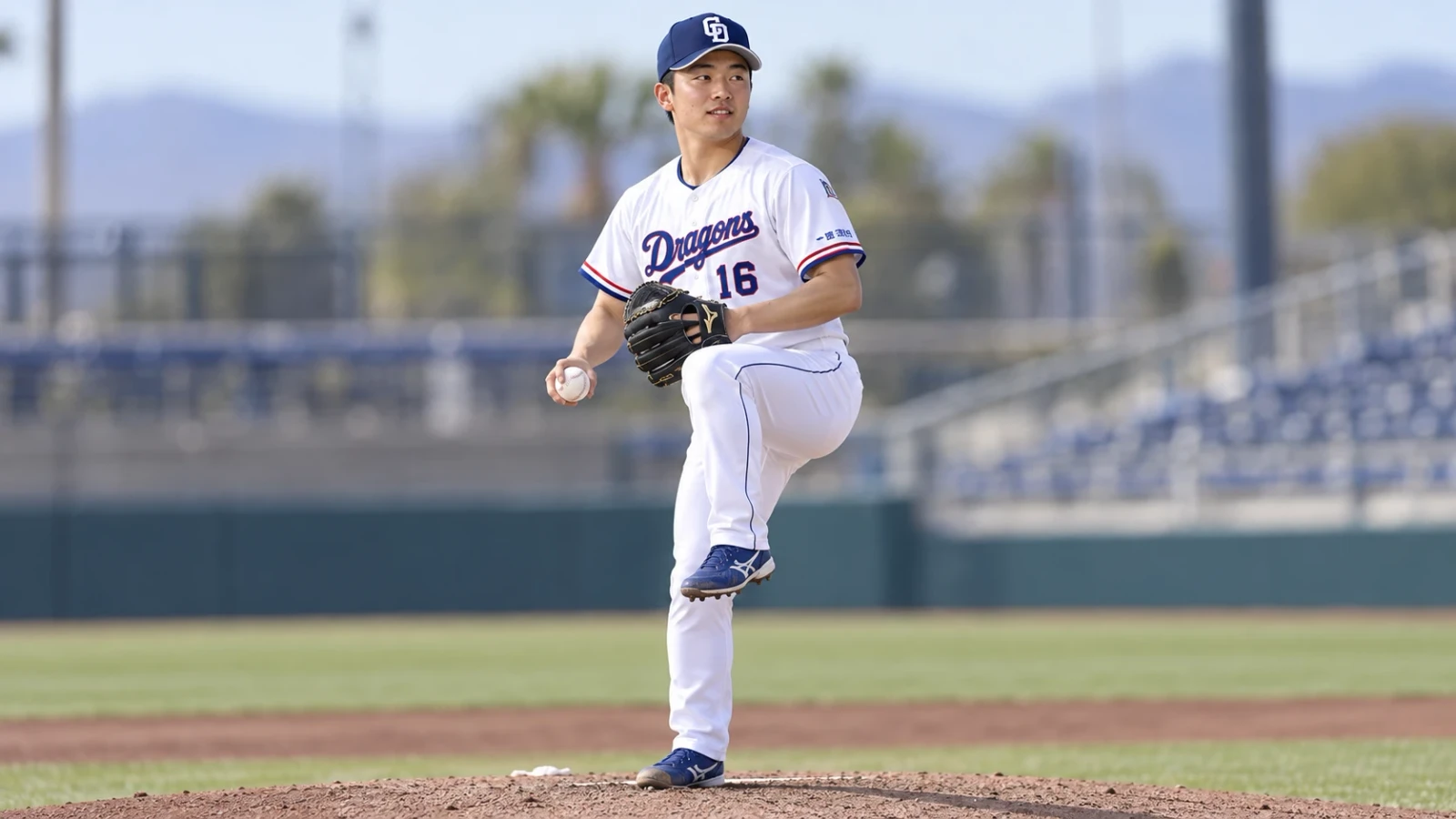 白いユニフォームの投手が、マウンドでグラブを構えて片足を上げている。